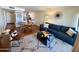 Cozy living room features a sectional sofa, stylish decor, and open layout to the kitchen and dining area at 3314 N 68Th St # 107, Scottsdale, AZ 85251