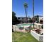 Fenced pool area with seating, landscaping and a barbecue are shown against a clear blue sky at 3314 N 68Th St # 107, Scottsdale, AZ 85251