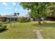 Sprawling backyard featuring mature trees, lush lawn, and a garden trellis at 3616 E Fairmount Ave, Phoenix, AZ 85018