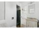 Bathroom featuring an adjacent bedroom, vanity and a walk-in shower at 3616 E Fairmount Ave, Phoenix, AZ 85018
