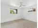 Bright bedroom featuring neutral walls, ceiling fan, carpet flooring and two windows allowing natural light at 3616 E Fairmount Ave, Phoenix, AZ 85018