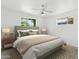 Bright bedroom featuring neutral walls, ceiling fan, carpet flooring and two windows allowing natural light at 3616 E Fairmount Ave, Phoenix, AZ 85018