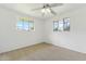 Bright, spacious bedroom with soft carpet, a ceiling fan, and two sunny windows at 3616 E Fairmount Ave, Phoenix, AZ 85018