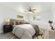 Bright bedroom featuring neutral walls, ceiling fan, carpet flooring and two windows allowing natural light at 3616 E Fairmount Ave, Phoenix, AZ 85018