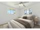 Comfortable bedroom with natural light, a ceiling fan, and two windows at 3616 E Fairmount Ave, Phoenix, AZ 85018