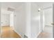 Hallway with neutral walls and wood flooring leading to various rooms at 3616 E Fairmount Ave, Phoenix, AZ 85018