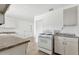 Functional kitchen featuring white appliances, tile flooring, and ample cabinet space at 3616 E Fairmount Ave, Phoenix, AZ 85018