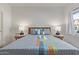 Well-lit bedroom showcasing a cozy bed with stylish bedding, side tables, and warm lamps at 3830 E Lakewood E Pkwy # 1007, Phoenix, AZ 85048