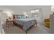 Comfortable bedroom with a gray quilt, warm lighting, and a bright window view at 3830 E Lakewood E Pkwy # 1007, Phoenix, AZ 85048