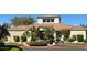 Community clubhouse with desert landscaping, red tile roof, and mature palm trees at 3830 E Lakewood E Pkwy # 1007, Phoenix, AZ 85048