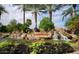 The Lakewood waterfall monument features lush desert landscaping and mature palm trees at 3830 E Lakewood E Pkwy # 1007, Phoenix, AZ 85048