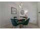 Inviting dining area featuring a round glass table with green velvet chairs and pendant lighting at 3830 E Lakewood E Pkwy # 1007, Phoenix, AZ 85048