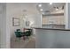 Open dining area featuring a glass table, velvet chairs, and modern lighting adjacent to the kitchen at 3830 E Lakewood E Pkwy # 1007, Phoenix, AZ 85048