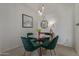 Bright dining area with a round glass table, velvet chairs, and modern pendant lighting at 3830 E Lakewood E Pkwy # 1007, Phoenix, AZ 85048