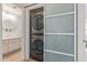 Modern laundry area with stacked washer/dryer units, next to a well-lit bathroom at 3830 E Lakewood E Pkwy # 1007, Phoenix, AZ 85048