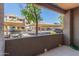 View from patio showcasing covered parking, lush trees, and the community buildings at 3830 E Lakewood E Pkwy # 1007, Phoenix, AZ 85048