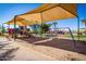 Community playground with slides, swings, and climbing structures under a shaded canopy at 3830 E Lakewood E Pkwy # 1007, Phoenix, AZ 85048