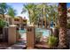 Gated pool area with lounge chairs and palm trees in a condominium community at 3830 E Lakewood E Pkwy # 1007, Phoenix, AZ 85048
