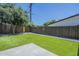 A lush, green artificial turf backyard features a charming fence line and a concrete patio for outdoor entertaining at 47 Spur Cir, Scottsdale, AZ 85251