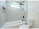 Tiled tub and shower combination featuring rain shower head and tiled shower niche at 47 Spur Cir, Scottsdale, AZ 85251