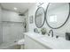 Modern bathroom features dual sinks, quartz countertops, sleek fixtures, and a walk-in shower at 47 Spur Cir, Scottsdale, AZ 85251