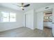 Bedroom with natural light, wood-look tile flooring, closet, and ceiling fan at 47 Spur Cir, Scottsdale, AZ 85251