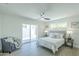 Bright bedroom with a ceiling fan, neutral decor, and access to the outdoor living space at 47 Spur Cir, Scottsdale, AZ 85251