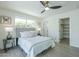A comfortable bedroom with a gray cushioned headboard, side tables, and a ceiling fan at 47 Spur Cir, Scottsdale, AZ 85251