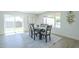 Dining room with wood-look flooring, a decorative rug, and a table that seats six next to sliding glass doors at 47 Spur Cir, Scottsdale, AZ 85251