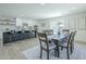 Eat-in dining area with a large island, barstool seating and a modern dining table at 47 Spur Cir, Scottsdale, AZ 85251
