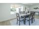 Cozy dining area with a large window overlooking the backyard, furnished with a wood table and seating for six at 47 Spur Cir, Scottsdale, AZ 85251