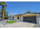 Single Gathering home with minimalist landscaping and a modern dark garage door at 47 Spur Cir, Scottsdale, AZ 85251