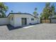 A single story home showcasing a spacious gravel backyard with easy access to the residence through glass sliding doors at 47 Spur Cir, Scottsdale, AZ 85251