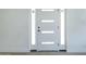 Bright white front door with glass panels and sidelights, offering ample natural light at 47 Spur Cir, Scottsdale, AZ 85251