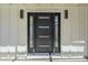 Contemporary black front door with sidelights, and exterior lighting at 47 Spur Cir, Scottsdale, AZ 85251