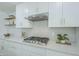 Updated kitchen features white cabinets, gold hardware, modern tile backsplash, and stainless steel appliances at 47 Spur Cir, Scottsdale, AZ 85251