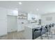 Modern kitchen with white cabinets, granite countertops, stainless steel appliances, and a central island with bar seating at 47 Spur Cir, Scottsdale, AZ 85251