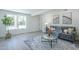 Well-lit living room features a plush sofa, modern rug, and large picture window at 47 Spur Cir, Scottsdale, AZ 85251
