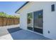 Covered patio with sliding glass door to backyard access featuring gravel and privacy fence at 47 Spur Cir, Scottsdale, AZ 85251