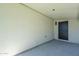 The room is a clean space with painted walls, a concrete floor, and a dark door for a minimalist design at 47 Spur Cir, Scottsdale, AZ 85251