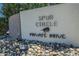Community signage with rock landscaping and the words 'Spur Circle Private Drive' at 47 Spur Cir, Scottsdale, AZ 85251