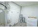 Compact utility room with water heater, paint buckets, and a cabinet, ideal for practical storage and functionality at 47 Spur Cir, Scottsdale, AZ 85251