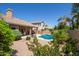 Lush backyard features a pool, covered patio, and mature landscaping at 623 W Harvard Ave, Gilbert, AZ 85233