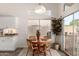 Cozy dining area with a round table, natural lighting, and views of the backyard at 623 W Harvard Ave, Gilbert, AZ 85233