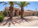 Inviting exterior with desert landscaping, mature palm trees, and a wide driveway at 623 W Harvard Ave, Gilbert, AZ 85233