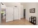 Hallway with hardwood floors and white doors leading to various rooms at 623 W Harvard Ave, Gilbert, AZ 85233