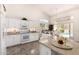Bright kitchen featuring white cabinets, stone countertops, and a center island overlooking a pool at 623 W Harvard Ave, Gilbert, AZ 85233