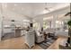 Bright and open living space with a modern kitchen view, light hardwood floors, and a cozy seating area at 623 W Harvard Ave, Gilbert, AZ 85233