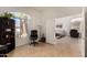 Office space with hardwood floors, a large window, and views into living room at 623 W Harvard Ave, Gilbert, AZ 85233