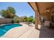 A backyard pool and covered patio offers a relaxing outdoor living space at 623 W Harvard Ave, Gilbert, AZ 85233